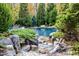 Luxury pool with stonework and landscaping, creating a tranquil oasis at 110 Bywater Way, Chapel Hill, NC 27516