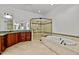 Spa-like bathroom with soaking tub, walk-in shower, and designer tile at 110 Bywater Way, Chapel Hill, NC 27516