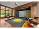 High-end golf simulator in a wood paneled game room at 110 Bywater Way, Chapel Hill, NC 27516