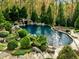 Inviting pool surrounded by lush landscaping and stone features at 110 Bywater Way, Chapel Hill, NC 27516