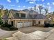 Large home with stone accents and a three-car garage at 110 Bywater Way, Chapel Hill, NC 27516