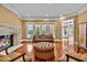 Cozy sitting room with fireplace, hardwood floors, and ample natural light at 110 Bywater Way, Chapel Hill, NC 27516