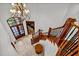 Elegant staircase with chandelier and wood railing at 110 Bywater Way, Chapel Hill, NC 27516