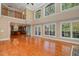 Spacious great room boasts hardwood floors, high ceilings, and a two-story wall of windows at 10336 Nash, Chapel Hill, NC 27517