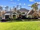 Luxury home with stone and shingle exterior, manicured lawn at 110 Bywater Way, Chapel Hill, NC 27516