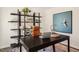 Home office with a large desk, shelving unit, and comfortable leather chair at 233 Holton St, Smithfield, NC 27577