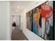 Bright hallway with large abstract art and a view into a living area at 233 Holton St, Smithfield, NC 27577