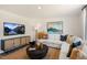 Living room featuring a sectional sofa, large TV, and modern decor at 233 Holton St, Smithfield, NC 27577