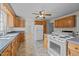 Kitchen features wood cabinets, appliances, and tile floor at 9847 Snow Camp Rd, Snow Camp, NC 27349