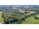 Aerial view of property showing a home and large field at 9847 Snow Camp Rd, Snow Camp, NC 27349