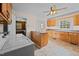 Bright kitchen with wood cabinets, island, and laundry area at 9847 Snow Camp Rd, Snow Camp, NC 27349