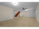 Large living room with carpet, ceiling fan, and staircase at 9847 Snow Camp Rd, Snow Camp, NC 27349