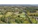 Aerial view of property showing home, pond, and expansive green space at 9847 Snow Camp Rd, Snow Camp, NC 27349