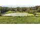 Aerial view of property with pond and pasture at 9847 Snow Camp Rd, Snow Camp, NC 27349