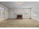 Living room with neutral carpeting and brick fireplace at 9847 Snow Camp Rd, Snow Camp, NC 27349