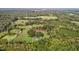 Aerial view of house and expansive property with barns at 9847 Snow Camp Rd, Snow Camp, NC 27349