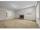 Living room with brick fireplace and neutral carpeting at 9847 Snow Camp Rd, Snow Camp, NC 27349