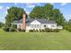 Charming white house with a covered porch and well-manicured lawn at 9847 Snow Camp Rd, Snow Camp, NC 27349