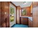 Laundry room with wood cabinets and backyard access at 9847 Snow Camp Rd, Snow Camp, NC 27349
