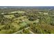Aerial view of property showing home, pond, and expansive green space at 9847 Snow Camp Rd, Snow Camp, NC 27349