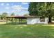 Rustic open-sided shed with a metal roof and white walls at 9847 Snow Camp Rd, Snow Camp, NC 27349