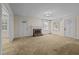 Living room with neutral carpeting and brick fireplace at 9847 Snow Camp Rd, Snow Camp, NC 27349