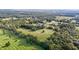 Aerial view of property showing a barn and large field at 9847 Snow Camp Rd, Snow Camp, NC 27349