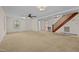 Living room features carpet, ceiling fan, and view of staircase at 9847 Snow Camp Rd, Snow Camp, NC 27349