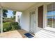 Front door entry with a glass storm door and brown shutters at 9847 Snow Camp Rd, Snow Camp, NC 27349