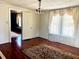 Bright dining room with hardwood floors and chandelier at 203 Peace St, Oxford, NC 27565