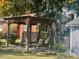 Wooden pergola with seating area and fire pit, ideal for outdoor relaxation at 203 Peace St, Oxford, NC 27565