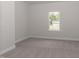 Bright bedroom with grey carpet and large window at 100 Lemon Drop Ln, Franklinton, NC 27525