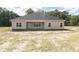 Tan house exterior with covered patio and yard at 100 Lemon Drop Ln, Franklinton, NC 27525