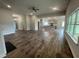Open concept living room with hardwood floors and views into kitchen area at 100 Lemon Drop Ln, Franklinton, NC 27525
