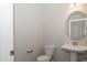 Clean powder room with pedestal sink and toilet at 100 Lemon Drop Ln, Franklinton, NC 27525
