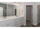 Double vanity bathroom with white cabinets and a large mirror. Includes a shower and linen closet at 100 Lemon Drop Ln, Franklinton, NC 27525