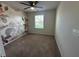 Bedroom with floral accent wall and ceiling fan at 443 Cross Country Way, Durham, NC 27703