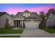 Curb appeal abounds at this charming craftsman home, featuring a two-car garage and inviting front porch at 12309 Aberdeen Chase Way, Durham, NC 27703