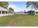 View of the house's side and backyard with detached workshop and screened enclosure at 2494 Joel Johnson Rd, Lillington, NC 27546