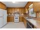 Bright kitchen with wood cabinets and appliances at 2494 Joel Johnson Rd, Lillington, NC 27546