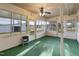 Sunroom with green carpet, ceiling fan, and heater at 2494 Joel Johnson Rd, Lillington, NC 27546