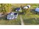 Aerial view of a house with detached workshop and barn on a large lot at 2494 Joel Johnson Rd, Lillington, NC 27546