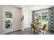 Bright dining area with glass table and four yellow chairs near kitchen at 113 Holmes Corner Dr, Smithfield, NC 27577