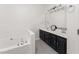 Double vanity bathroom with dark wood cabinets and a bathtub at 4445 Still Pines Dr, Raleigh, NC 27613