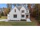 Two-story white brick home with a gray roof, wooden door, and landscaping at 2105 Gentry Rd, Wake Forest, NC 27587