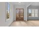 Bright and spacious entryway with hardwood floors, large windows, and a stunning wooden door at 2105 Gentry Rd, Wake Forest, NC 27587