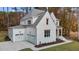 Two-story white brick home with two-car garage and landscaping at 2105 Gentry Rd, Wake Forest, NC 27587