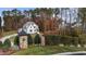 Home entrance with a stone gate and landscaping in a wooded community at 2105 Gentry Rd, Wake Forest, NC 27587