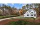 White two-story house with a long driveway, surrounded by trees at 2105 Gentry Rd, Wake Forest, NC 27587