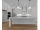 Modern kitchen with white cabinets, quartz countertops, and large island at 2105 Gentry Rd, Wake Forest, NC 27587